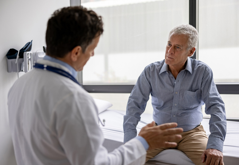 Physician-discussing-cancer-screening-process-with-male-patient